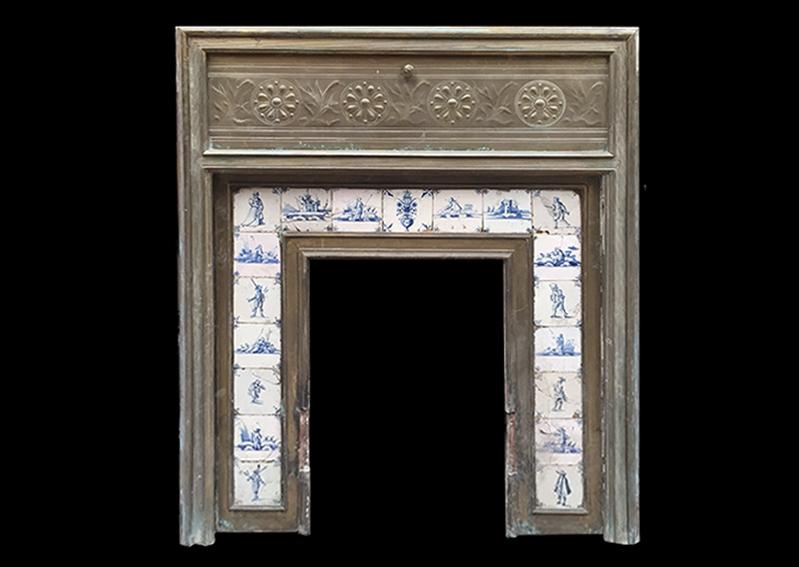An unusual brass fire surround with delft tiles to insert