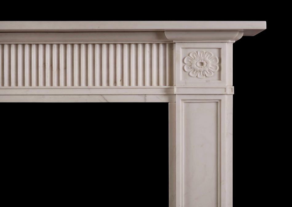 A late 18th century style white marble fireplace