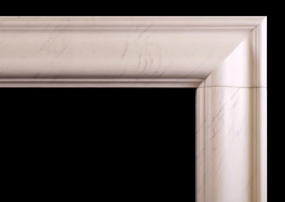 A white marble bolection fireplace