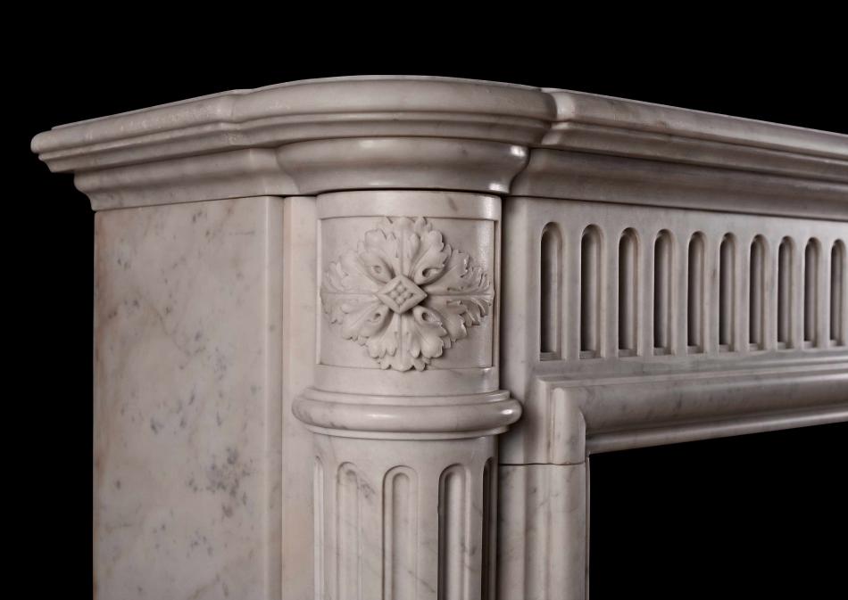 An unusually tall French marble fireplace
