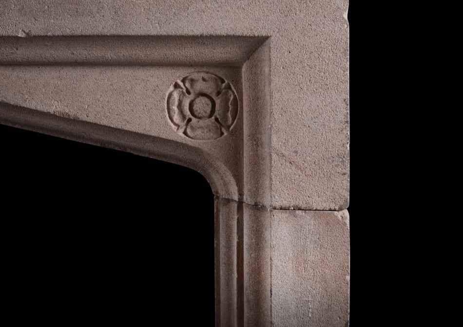 A carved Bath stone fireplace in the Gothic style