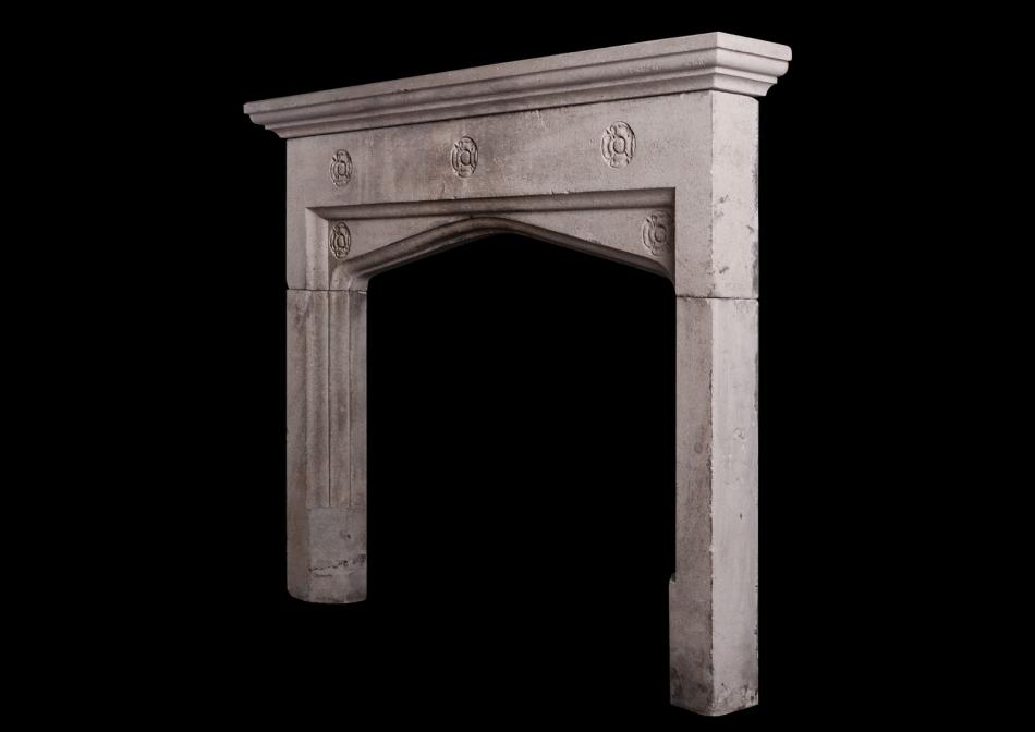A carved Bath stone fireplace in the Gothic style