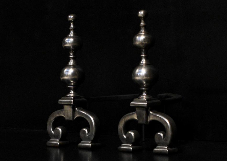 A pair of 19th century polished iron firedogs