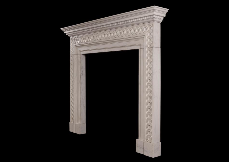 A white marble fireplace with guilloche carving