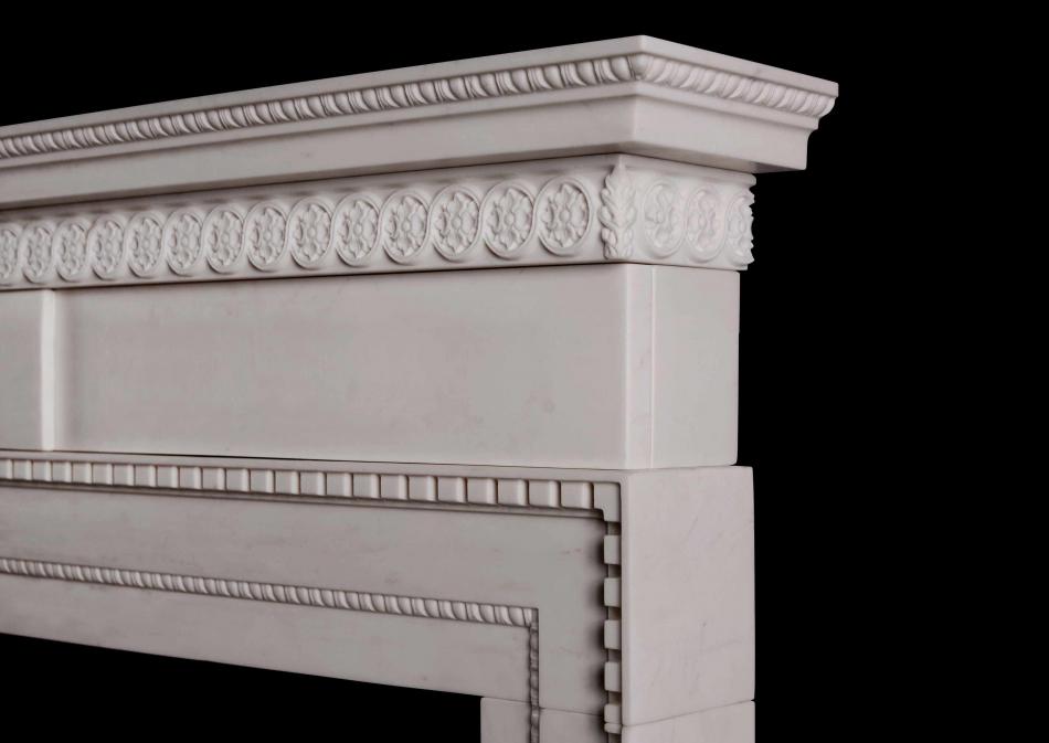 A delicate, late Georgian style white marble fireplace