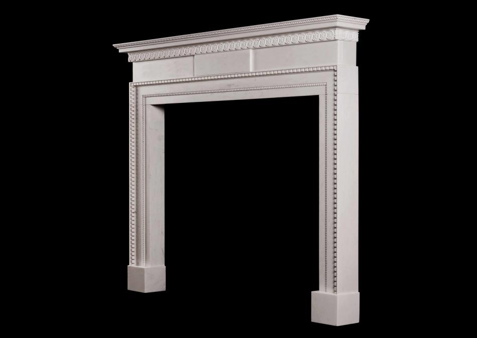 A delicate, late Georgian style white marble fireplace