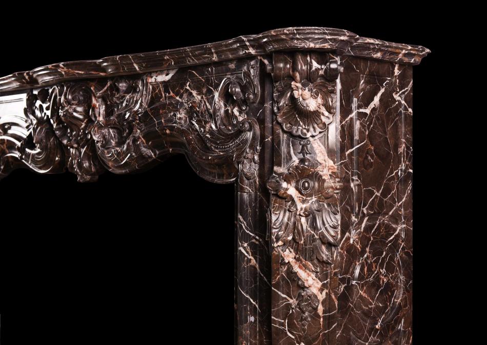 A sumptuous Emperador marble Louis XV style marble fireplace