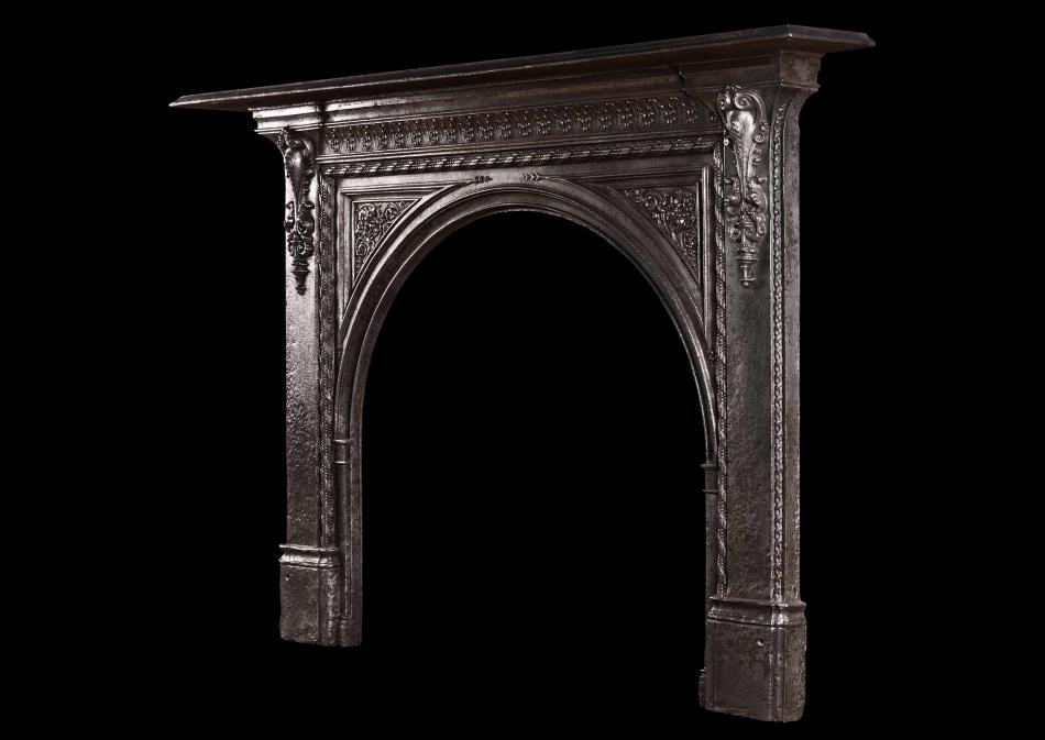 A 19th century iron fireplace with arched opening