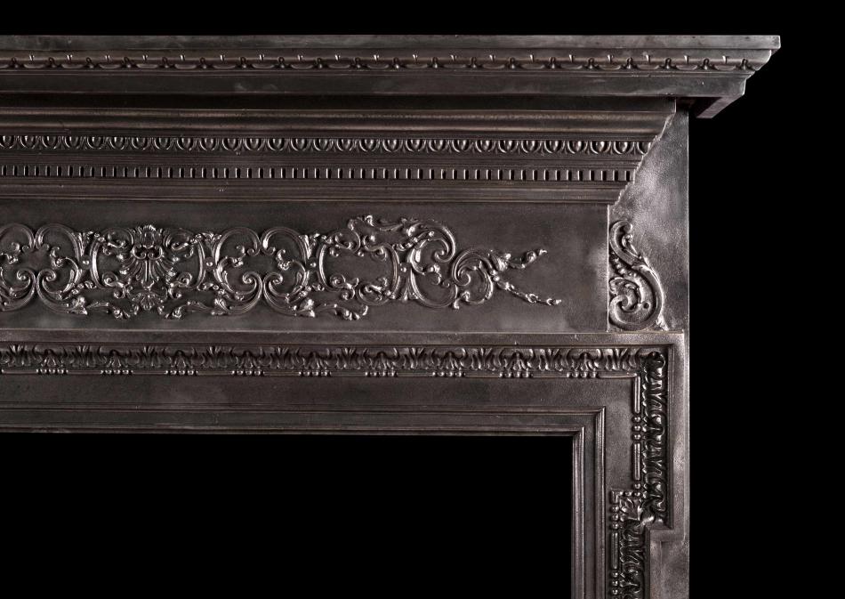 A cast iron fireplace with filigree frieze