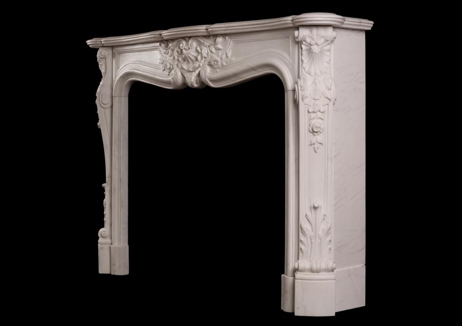 An ornately carved Louis XV marble fireplace