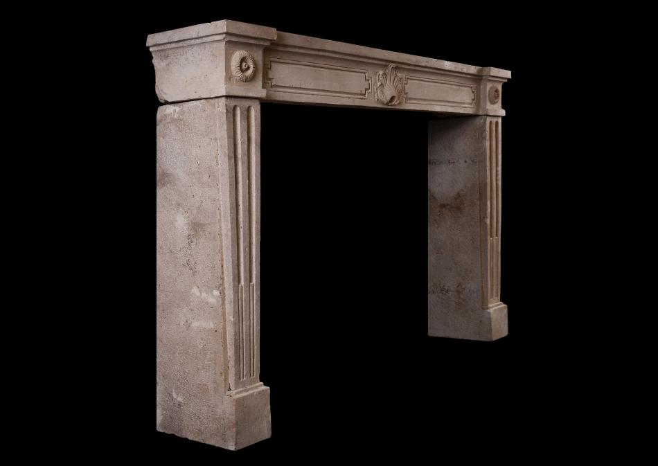 A rustic French Louis XVI antique fireplace