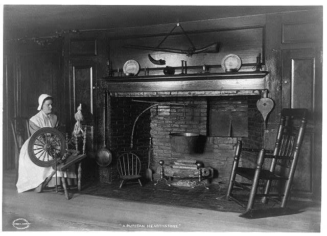 An American Puritan fireplace in a 1906 photograph, clearly showing the firedogs in situ. Photo: Library of Congress.