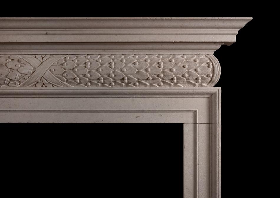 A mid 18th century style antiqued limestone fireplace