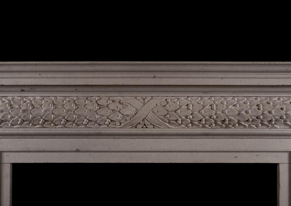 A mid 18th century style antiqued limestone fireplace