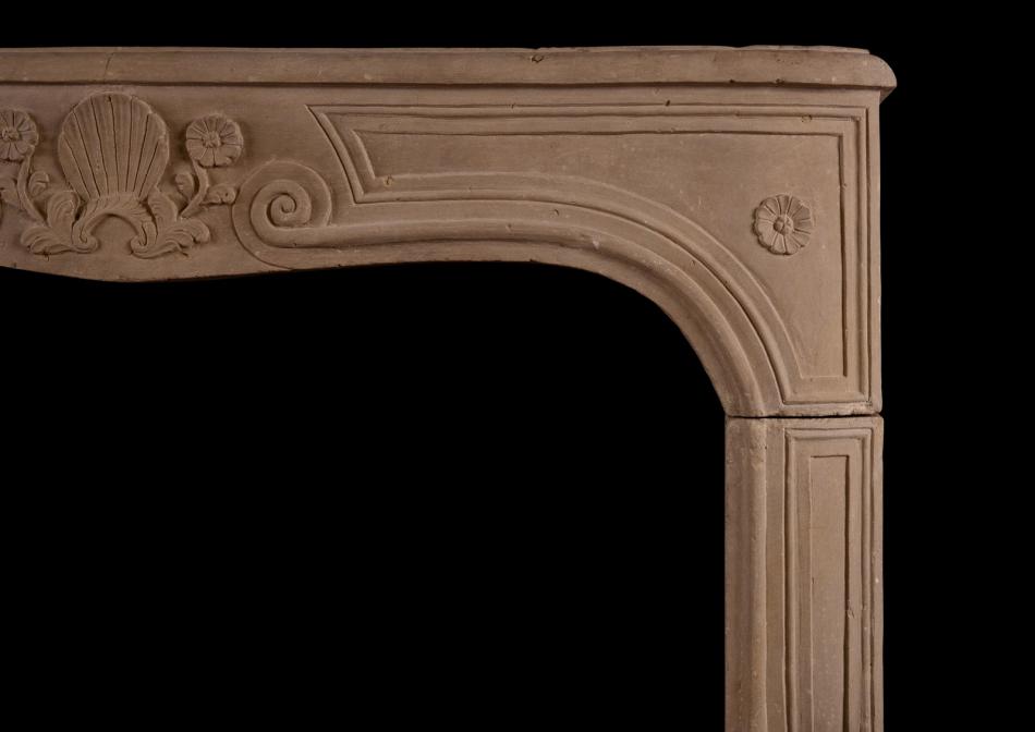 A carved Louis XV limestone fireplace