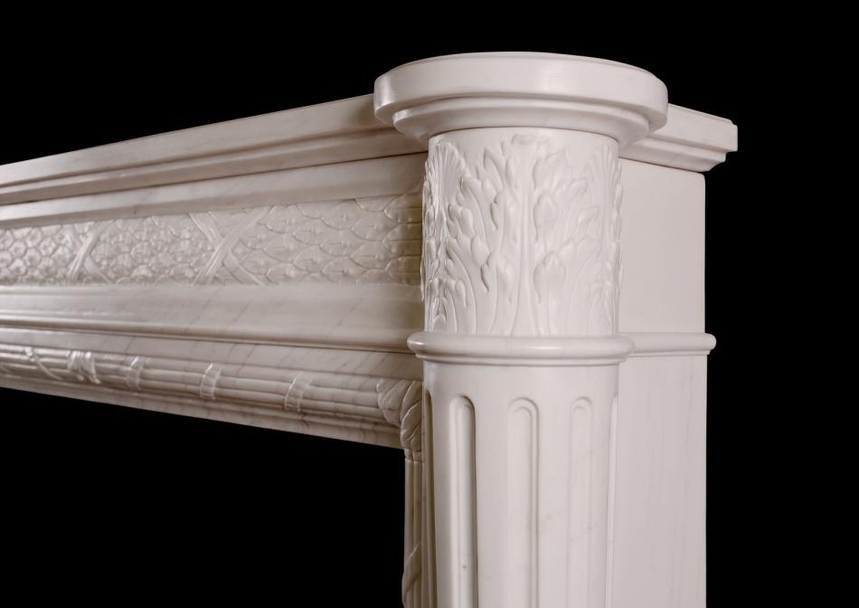 A Louis XVI style marble fireplace with tapering columns