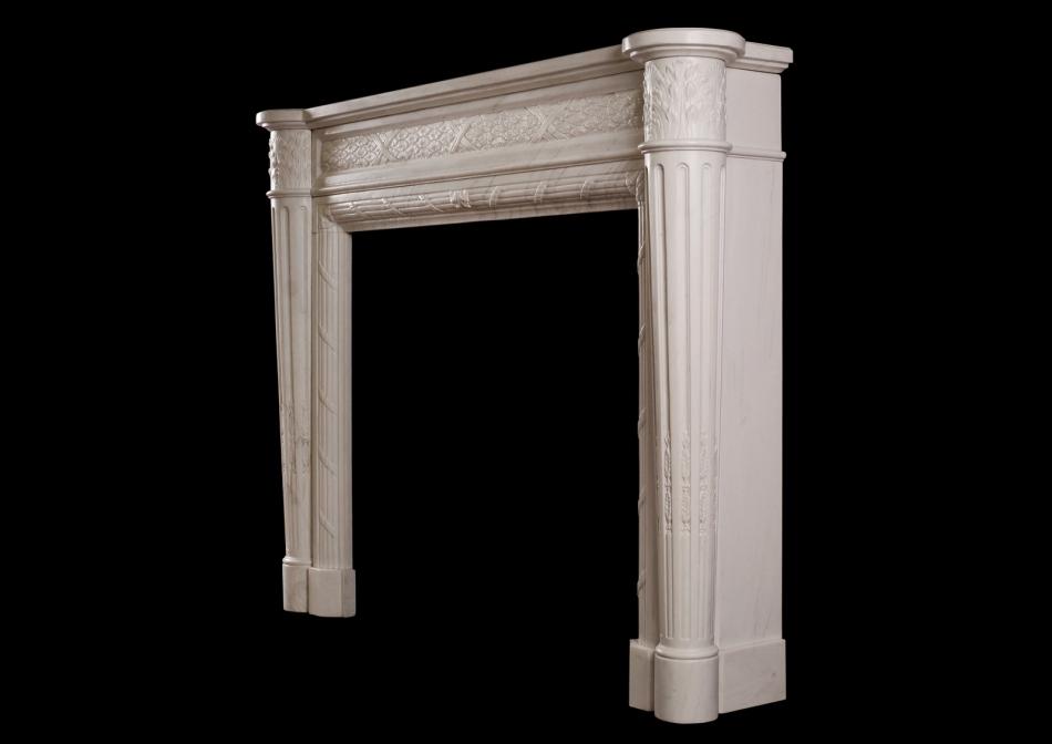 A Louis XVI style marble fireplace with tapering columns
