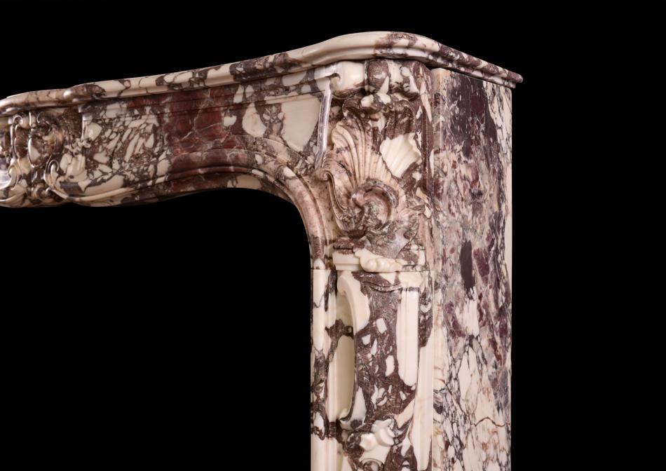 A period Louis XV fireplace in Breche Violette marble