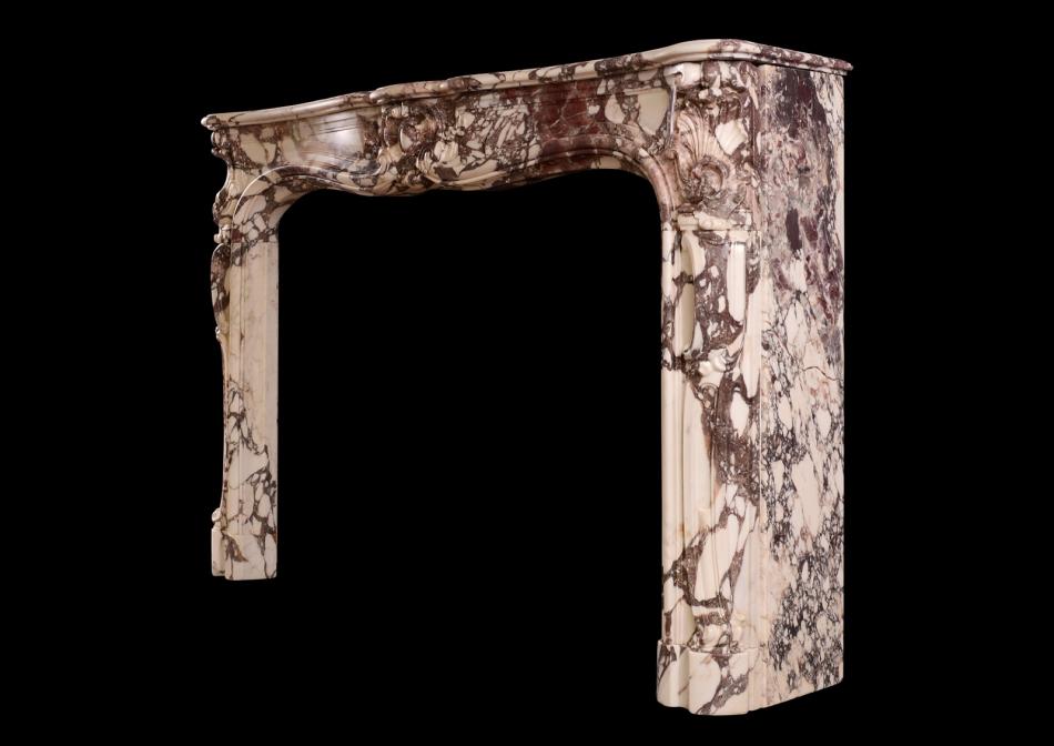 A period Louis XV fireplace in Breche Violette marble