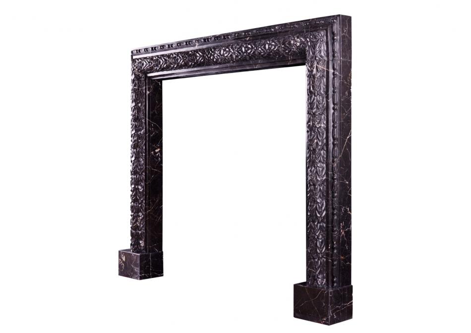 An elegant carved bolection fireplace in Nero Marquina marble