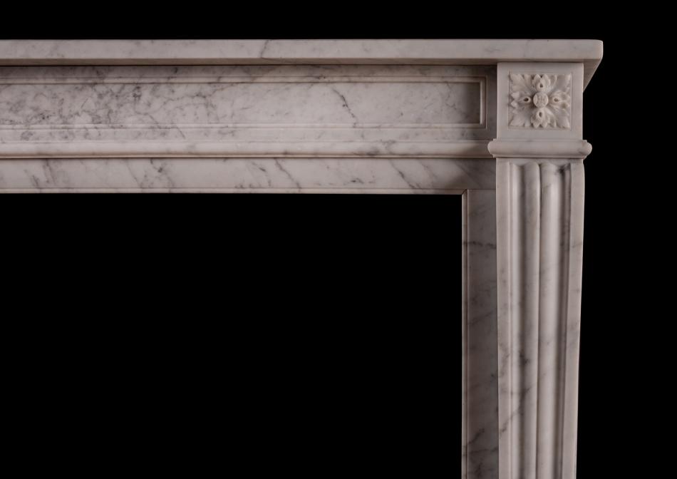 A 19th century carved marble fireplace in the Louis XVI style