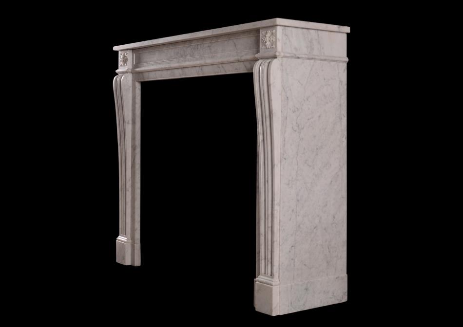 A 19th century carved marble fireplace in the Louis XVI style