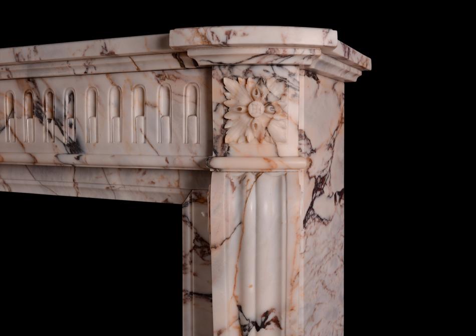 A 19th century French Louis XVI style fireplace in veined marble