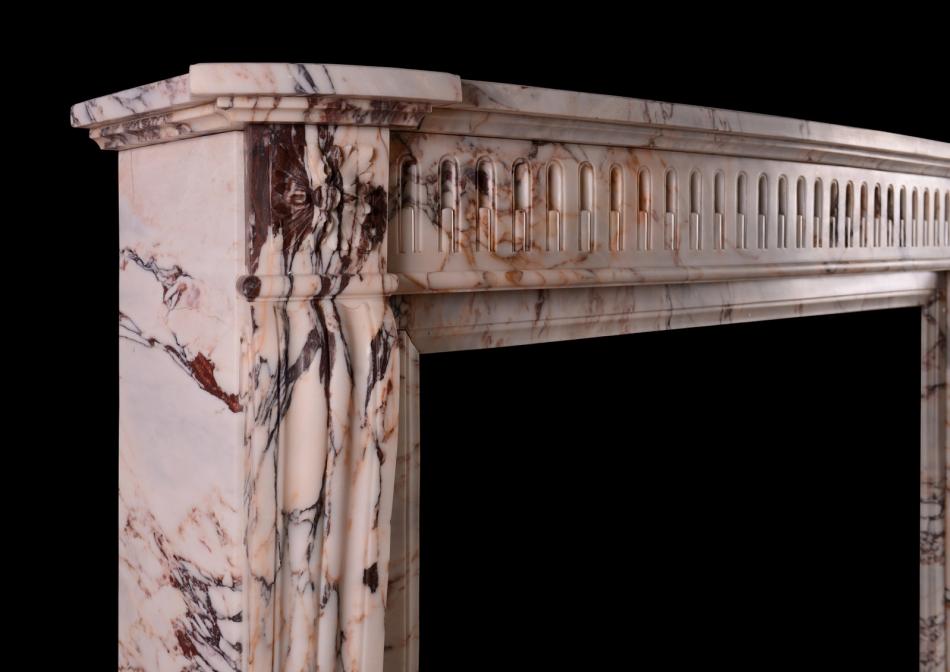 A 19th century French Louis XVI style fireplace in veined marble