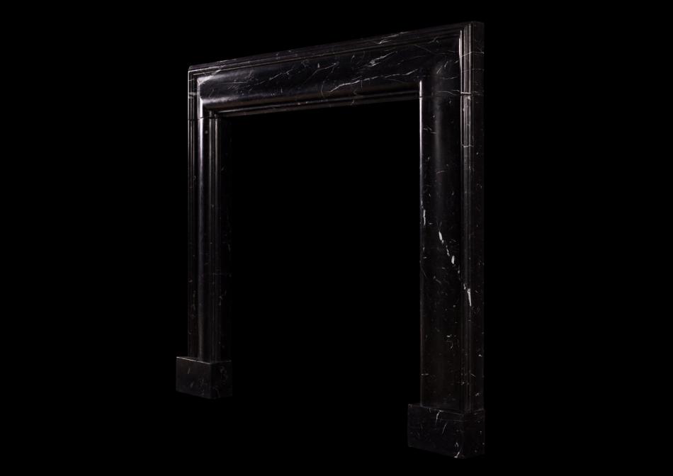 An English moulded bolection fireplace in Nero Marquina marble