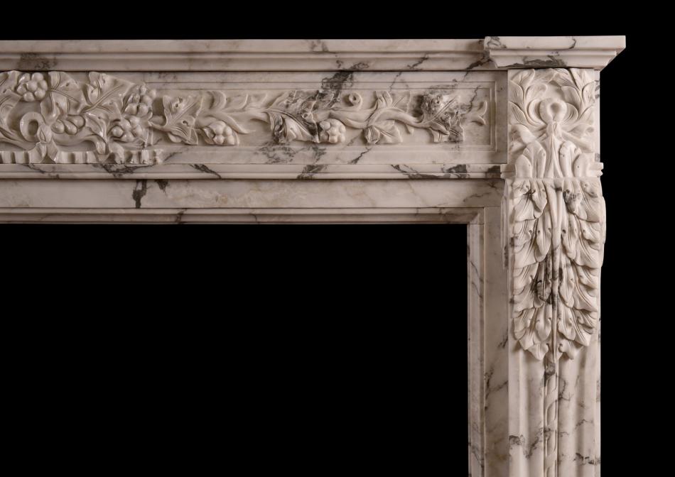 A carved French Arabescato marble fireplace