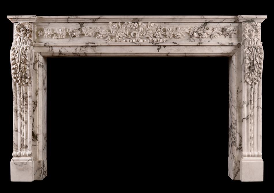 A carved French Arabescato marble fireplace