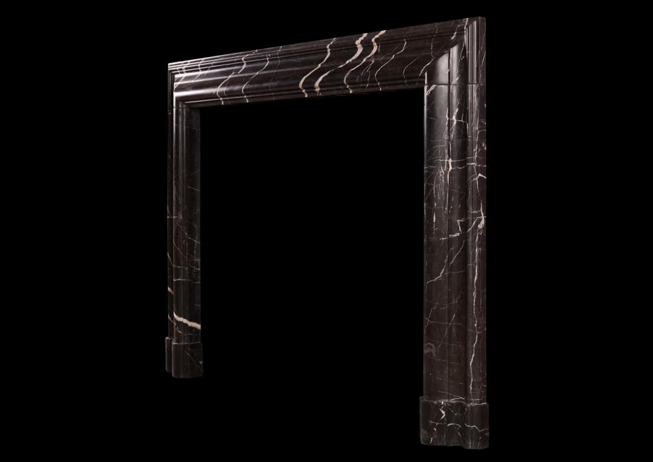 A bolection fireplace in Brown Marquina marble