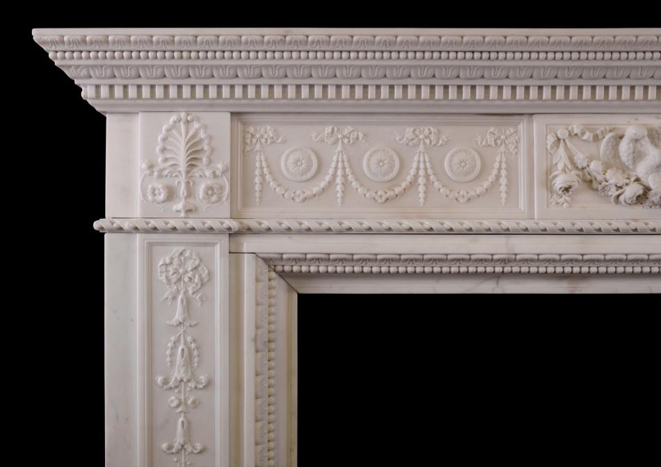 A finely carved Statuary marble fireplace with birds to centre block