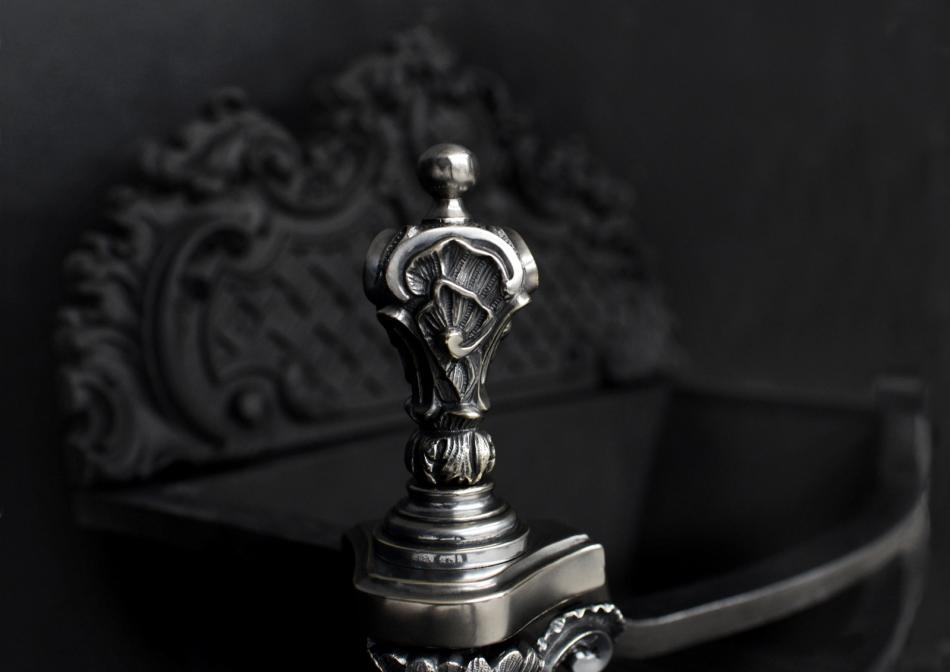 A decorative Rococo firegrate in German silver
