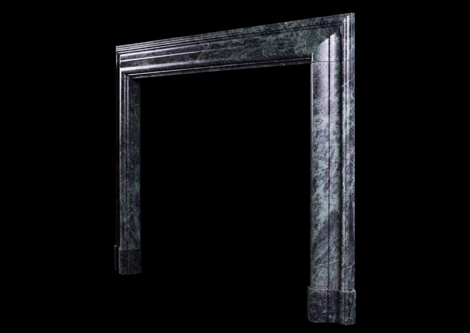 A Queen Anne style bolection fireplace in green marble