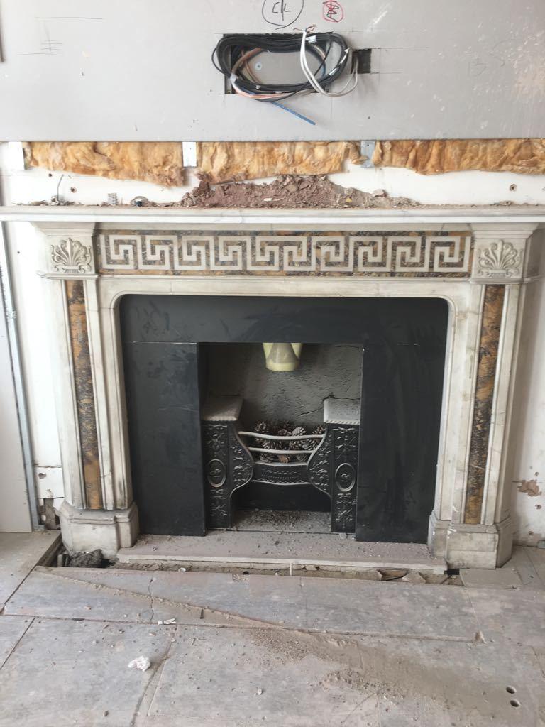 An early 19th century Statuary and Siena marble fireplace