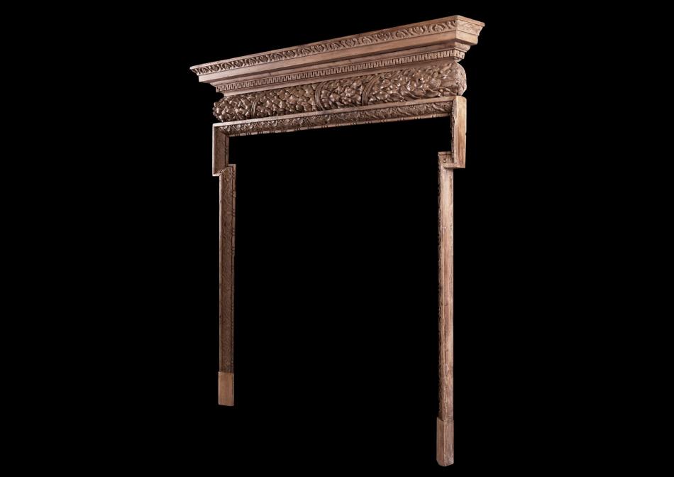 A carved pine fireplace in the Georgian style
