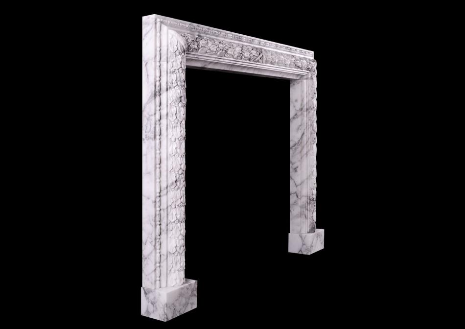 A carved bolection fireplace in Arabescato marble