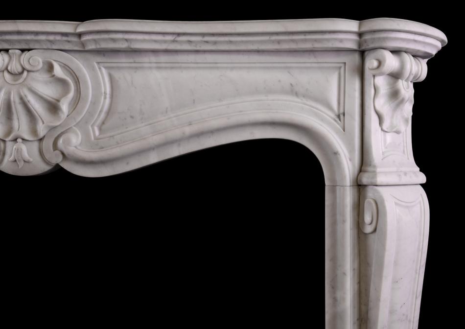 A French Louis XV style fireplace in Italian Carrara marble