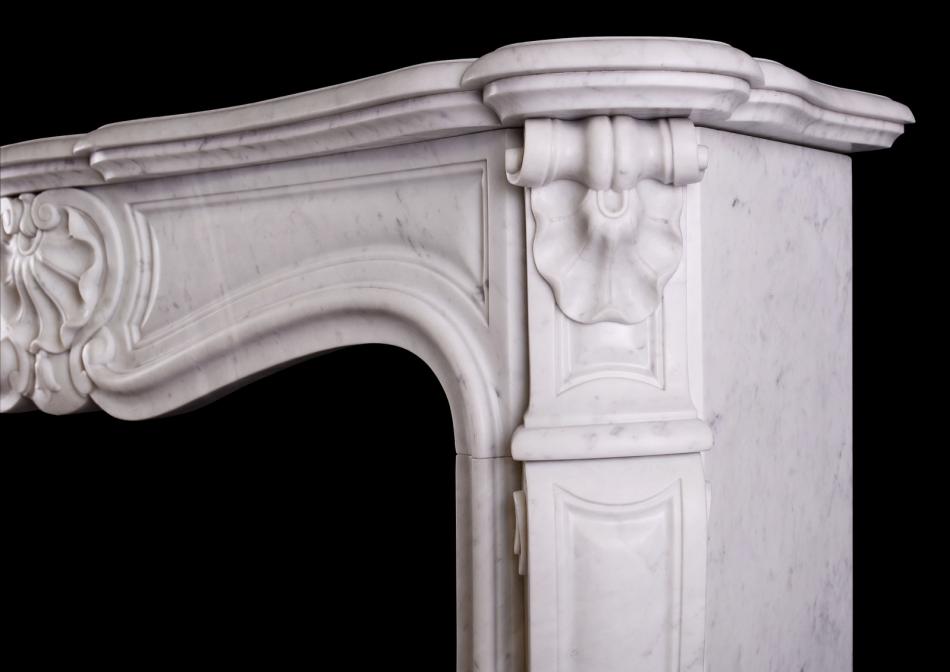 A French Louis XV style fireplace in Italian Carrara marble