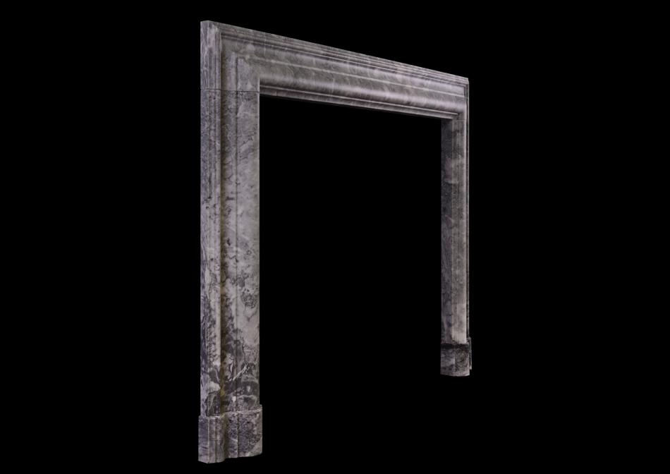 A grey and white marble bolection fireplace