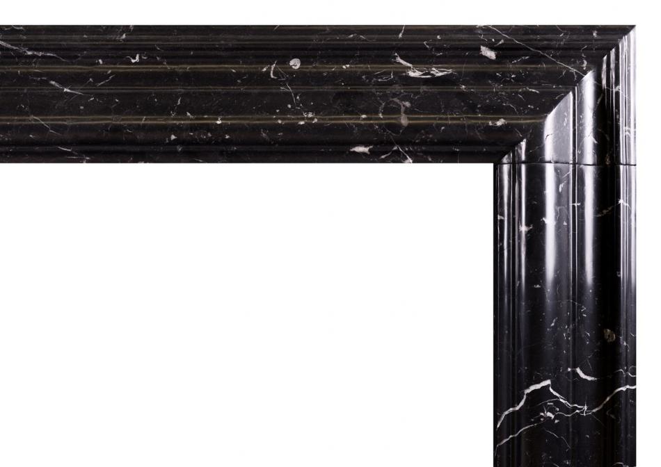 A bolection fireplace in Nero Marquina marble