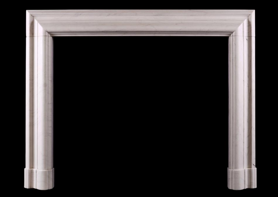 A white marble bolection fireplace