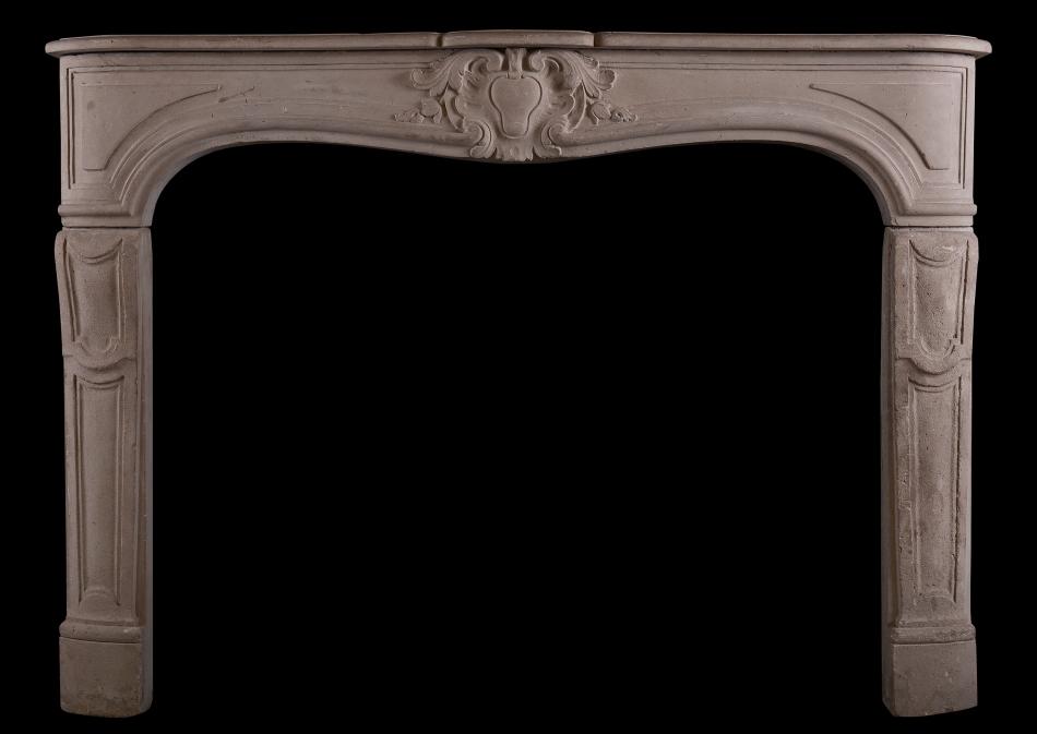 A carved Louis XV style limestone fireplace