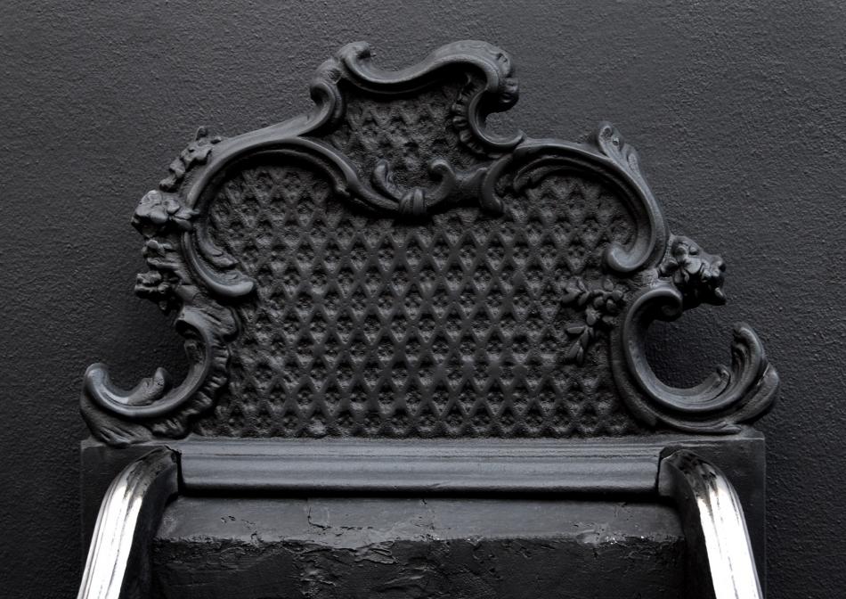 A brass and steel Rococo firegrate