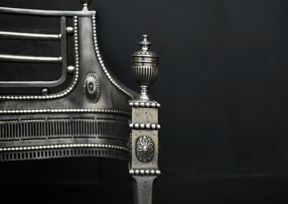 A polished steel fire basket in the Georgian style
