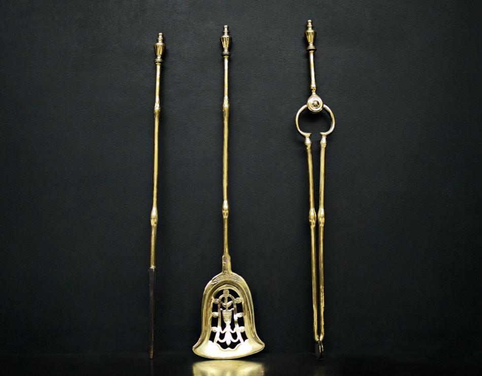 A set of brass firetools