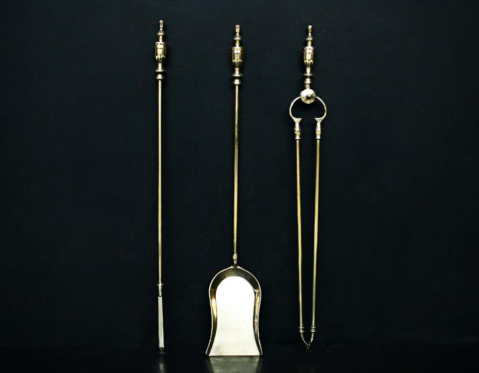 A set of brass fire irons