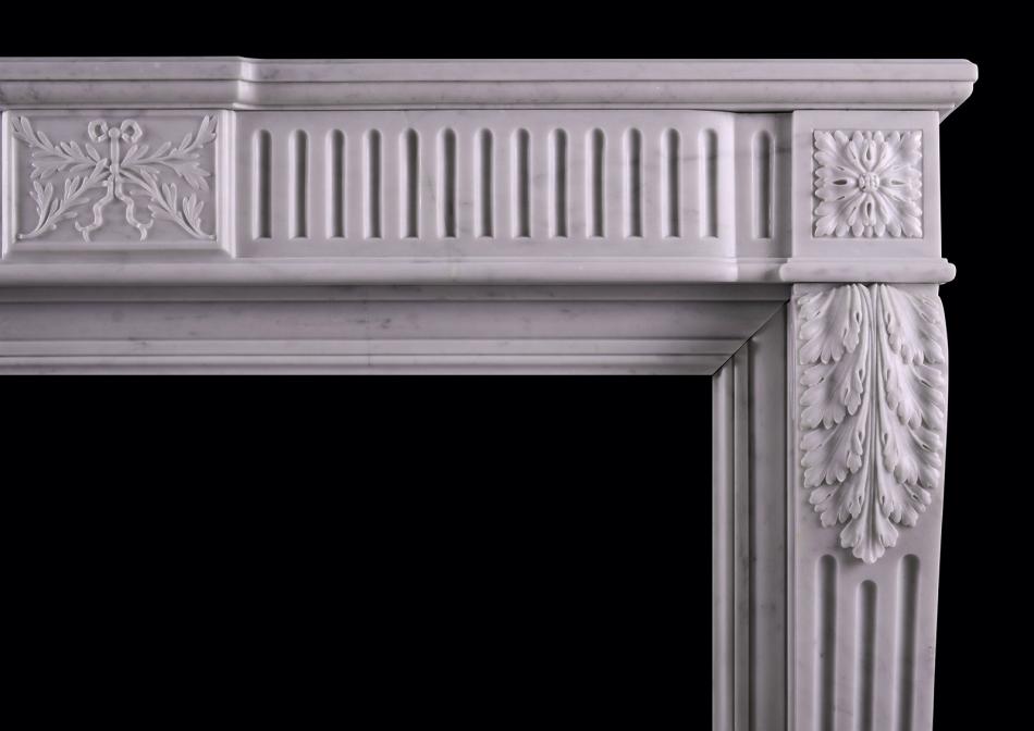 A carved Carrara marble fireplace in the Louis XVI manner
