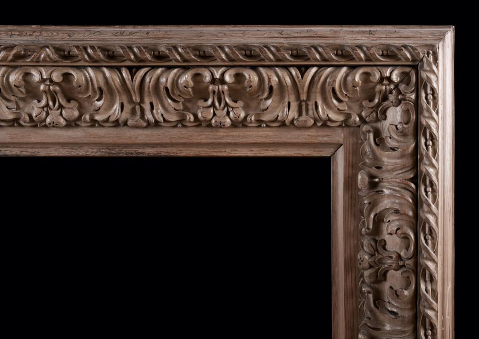 A carved wood bolection fireplace